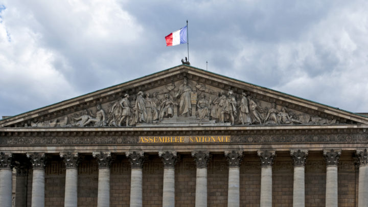 View on National Assembly building in Paris, with french flag flying