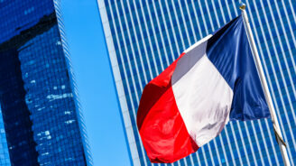 French flag with business building on background
